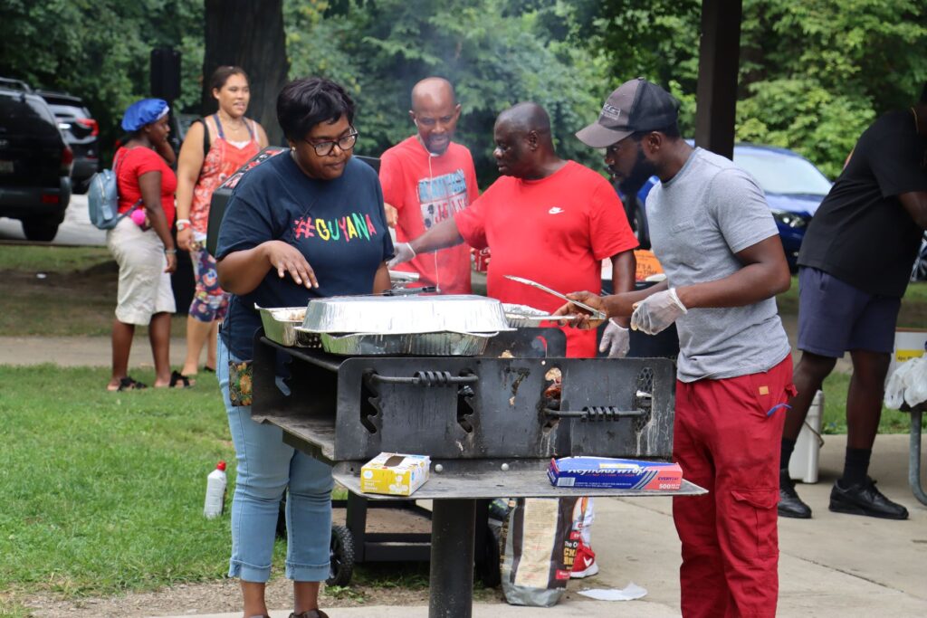 Volunteers grill food for the congregation at a Faith Klinik church picnic